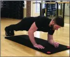  ?? (Arkansas Democrat-Gazette/Celia Storey) ?? Josh Holt, fitness director at Little Rock Racquet Club, does the Archer Bodyweight Skull Crusher without slipping and crushing his skull.