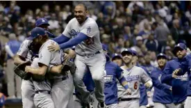  ?? AP ?? The LA Dodgers celebrate after beating the Brewers.—