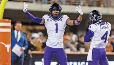  ?? AP PHOTO/STEPHEN SPILLMAN ?? TCU receiver Quentin Johnson (1) celebrates a touchdown with teammate Taye Barber (4) against Texas. The Horned Frogs are firmly in the running to make the BCS playoffs.