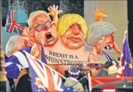  ?? REUTERS ?? ▪ A caricature of Britain's Prime Minister Theresa May (right) Boris Johnson (centre) and Michael Gove is paraded by anti-Brexit protesters in London.