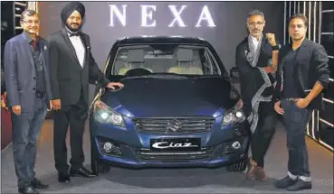  ??  ?? (L to R) Tarun Garg, Executive Vice President - Marketing, RS Kalsi, Senior Executive Director - Marketing and Sales from Maruti Suzuki India Limited, designers Nikhil and Shantanu with Ciaz displayed at Lakmé Fashion Week PHOTOS: HTCS