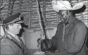  ??  ?? Diplomatic mission: Sir Chandos Blair receives a gift from Idi Amin in 1975
