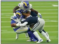  ?? (AP/Ashley Landis ) ?? Los Angeles Rams defensive end Aaron Donald (left) and outside linebacker Leonard Floyd smother Dallas Cowboys quarterbac­k Dak Prescott during the Rams’ 20-17 victory Sunday in Inglewood, Calif. Dallas managed three points on its six drives in the second half.