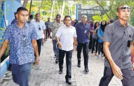  ?? REUTERS ?? ■ Maldives President Abdulla Yameen (centre), who is seeking reelection, arrives to cast his vote at a polling station in Male on Sunday.
