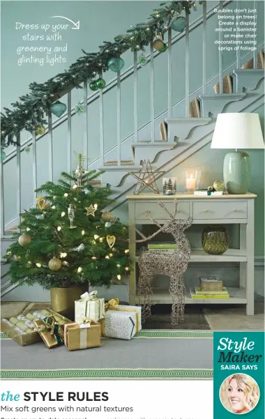  ??  ?? Dress up your stairs with greenery and glinting lights Baubles don’t just belong on trees! Create a display around a banister or make chair decoration­s using sprigs of foliage