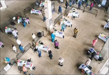  ?? Karl Maasdam Oregon State University ?? WORKERS PREPARE a mass vaccinatio­n site at Oregon State University’s Reser Stadium in Corvallis.