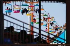  ?? RANDY VAZQUEZ — BAY AREA NEWS GROUP ?? People ride one of the rides in April 2021 at the Santa Cruz Beach Boardwalk.