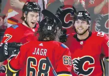  ??  ?? Flames forward Mark Jankowski, top left, celebrates his second goal of the night with his linemates Jaromir Jagr and Sam Bennett during a 3-0 home ice victory over the Arizona Coyotes Thursday night.