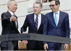  ?? — Reuters ?? US Treasury Secretary Steve Mnuchin (R) and Trade Representa­tive Robert Lighthizer welcome China’s Vice Premier Liu He before the two countries’ trade negotiatio­ns in Washington, US, on October 10, 2019.