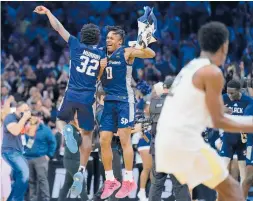  ?? MATT ROURKE/AP ?? Saint Peter’s Jaylen Murray, left, and Latrell Reid celebrate after beating Purdue in the Sweet 16 on Friday in Philadelph­ia.