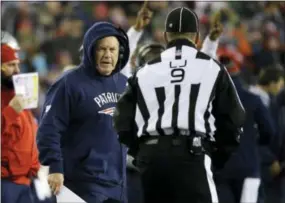  ?? ELISE AMENDOLA — THE ASSOCIATED PRESS ?? New England Patriots head coach Bill Belichick argues with line judge Mark Perlman (9) during the first half of the AFC championsh­ip NFL football game against the Pittsburgh Steelers, Sunday in Foxborough, Mass.