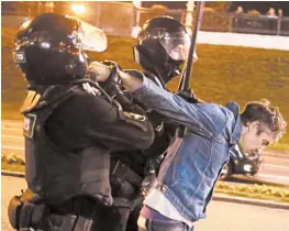  ?? TUT.BY ?? Riot police detain a protester during an opposition rallyWedne­sday in the Belarusian capital city of Minsk.