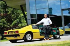  ?? — Reuters ?? Matt Windle, Managing Director of Lotus, stands with a yellow Lotus Esprit car during an interview at the car plant headquarte­rs in Hethel.