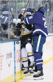  ?? CANADIAN PRESS FILE PHOTO ?? Toronto Maple Leafs defenceman Jake Muzzin, right, checks Pittsburgh’s Jake Guentzel last Saturday.