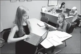  ?? NWA Democrat-Gazette/DAVID GOTTSCHALK ?? Kali Daniels (left), a fourth-grader at Fayettevil­le Virtual Academy, arrives Tuesday in Melissa Green’s fourth- and fifth-grade class at the school in Fayettevil­le. The school continues to expand in its second year and has added grades nine through 12...