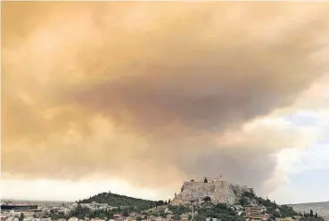  ?? [AP PHOTO] ?? A plume of smoke turns large parts of the sky orange above the ancient Acropolis hill as a forest fire burns Monday in a mountainou­s area west of Athens, sending nearby residents fleeing.