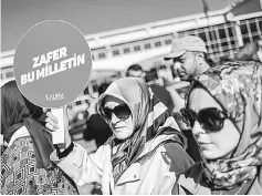  ??  ?? A woman holds a placard reading ‘Victory belongs to the Nation’ in front of the Silivri prison courthouse.— AFP photo