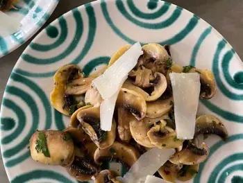  ?? Cathy Thomas, Orange County Register ?? Marinated Mushroom Salad is shown served with shaved Parmesan cheese.