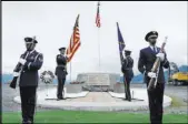 ?? The Associated Press ?? The Alaska Air National Guard honor guard presents colors Saturday at a plaque dedication ceremony in Valdez, Alaska, for 1964 plane crash victims.