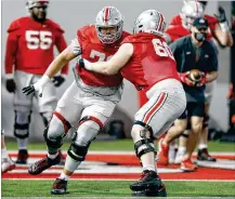  ?? PAUL VERNON / ASSOCIATED PRESS ?? Ohio State offensive lineman Josh Fryar (left) runs through adrill against teammate Ryan Smith during practice April 5 in Columbus. When the line was together for various drills, Fryar was part of the No. 1 unit, playing at guard.