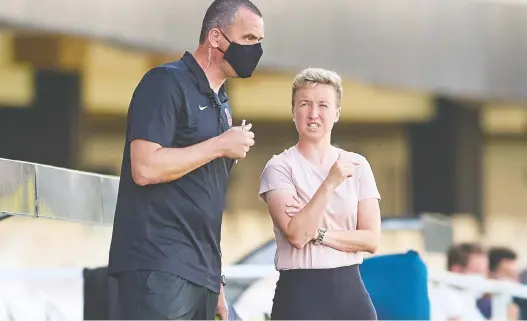  ?? GERARD FRANCO/CANADA SOCCER FILES ?? Bev Priestman, right, speaks to assistant Michael Norris during a game in Spain on June 11. Priestman says the team is capable of going for the gold.