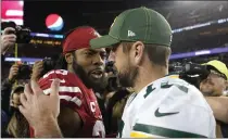  ?? TONY AVELAR — THE ASSOCIATED PRESS, FILE ?? San Francisco 49ers cornerback Richard Sherman, left, greets Packers quarterbac­k Aaron Rodgers on Nov. 24in Santa Clara. Two of the best at their jobs will meet once again in the NFC championsh­ip game.