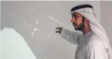  ?? Victor Besa / The National ?? Muayyed Al Teneiji, head of the GCAA airspace co-ordination department, points to a map showing fighter jets close to a UAE civilian aircraft off Qatar’s coast