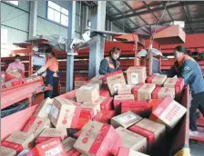  ?? XU JUNYONG / FOR CHINA DAILY ?? Employees sort packages at an express delivery company in Hangzhou, Zhejiang province.