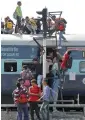  ?? Reuters ?? Passengers make use of a signal light pole to climb atop an overcrowde­d train at a railway station in Ajmer on Sunday. —