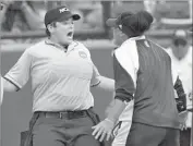  ?? Sarah Phipps Associated Press ?? BRUINS FIRST-BASE COACH Lisa Fernandez was ejected after arguing with umpire Erin Peterson, left.