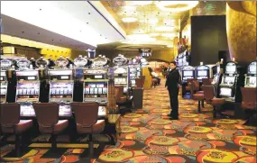  ?? Bob Child / Associated Press ?? One of the slot machine rooms at the MGM Grand Hotel at the Foxwoods Resort Casino in Mashantuck­et is shown in this May 13, 2008, photo. Three of Gov. Ned Lamont’s top agency leaders on Wednesday got first-hand looks at the preparatio­ns for a partial reopening at Foxwoods on June 1.
