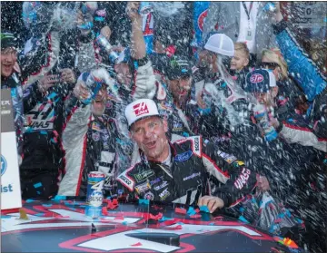  ?? Matt Bell / AP ?? Clint Bowyer celebrates with his crew after winning Monday’s NASCAR Cup Series race at Martinsvil­le Speedway.