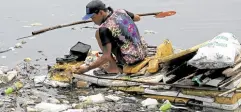  ?? —RICHARD A. REYES ?? GARBAGE HUNT In this June 2023 photo, a man collects recyclable materials among piles of garbage, mostly plastic, floating near a portion of Manila Bay near Bulungan Market in Parañaque City.