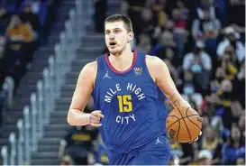  ?? JEFF CHIU/AP ?? Denver’s Nikola Jokic has won his second consecutiv­e Most Valuable Player award after a season in which he finished with numbers never before seen in NBA history. He is averaging 27.1 points, 13.8 rebounds and 7.9 assists this season.