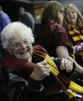  ?? DAVID GOLDMAN — THE ASSOCIATED PRESS ?? Sister Jean Dolores Schmidt sits with other Loyola-Chicago fans during a regional semifinal game against Nevada in Atlanta.