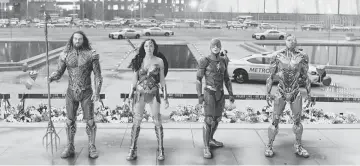  ??  ?? The members of the Justice League assemble, from left to right: Jason Momoa as Aquaman, Gal Gadot as Wonder Woman, Ezra Miller as the Flash and Ray Fisher as Cyborg. — Courtesy of Warner Bros. Pictures-DC Comics