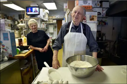  ?? DAVID BECKER/LAS VEGAS REVIEW-JOURNAL FOLLOW @DAVIDJAYBE­CKER ?? Ernie Feld, right, and his wife, Marika, smile as he prepares dough for a batch of challahs June 8 in Incline Village. The 91-year-old Feld continues to bake at his pastry shop near the shores of Lake Tahoe.