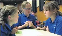  ??  ?? Tough questions . . . Millers Flat year 6 pupils (from left) Honor Garden (10), Molly Hansen (11) and Cortney Thompson (11) discuss their answer in the year 56 Extra! current events quiz.