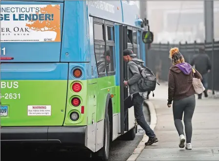  ?? SEAN D. ELLIOT/THE DAY ?? Riders board South East Area Transit buses Friday on Water Street in New London.