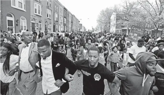  ?? KENNETH K. LAM/BALTIMORE SUN PHOTOS ?? Members of Freddie Gray’s family joined protesters Tuesday evening as they marched to the Western District police station.