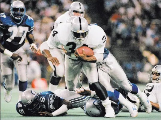  ?? Barry Sweet The Associated Press ?? Bo Jackson runs over Seahawks safety Kenny Easley in a 1987 game in which Jackson finished with 221 yards, including a 91yard touchdown run. Jackson also scored on a 2-yard run in which he memorably ran over linebacker Brian Bosworth.