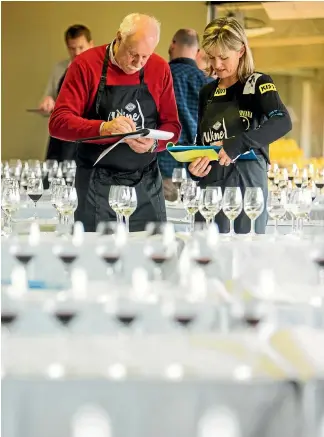  ??  ?? Wine judges like Jim Harre´ and Sarah-Kate Dineen will try more than 100 wines a day during a competitio­ns.
