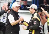  ?? Michael Conroy / Associated Press ?? Car owner Roger Penske, left, congratula­tes driver Simon Pagenaud after he won the pole during qualificat­ion for the 2019 Indianapol­is 500.