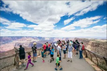  ?? John Burcham/New York Times ?? Visitors admire the view at the Grand Canyon in May 2018. In the wake of the pandemic, family vacations are likely to become shorter and domestic options more popular.