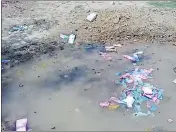  ??  ?? Ballot papers thrown into a pit in Pratapgarh on Monday.