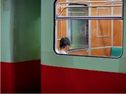  ??  ?? A passenger inside a subway train in Pyongyang, North Korea