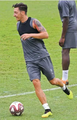  ?? — AFP ?? Arsenal’s Mesut Ozil at a training session in their pre-season tour for the Internatio­nal Champions Cup in Singapore on Wednesday.