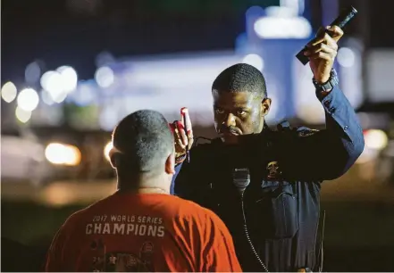  ?? Photos by Godofredo A. Vasquez / Staff photograph­er ?? Harris County Precinct 8 Deputy Constable Jonathan Toliver administer­s a field sobriety test to a man suspected of driving while intoxicate­d on the Interstate 45 frontage road earlier this month in Houston.