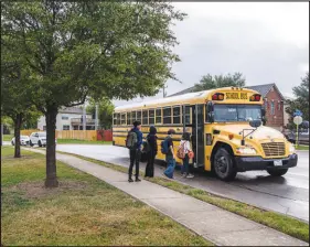  ?? MATTHEW BUSCH / THE NEW YORK TIMES ?? A school bus arrives late to pick up children on the way to school Monday in San Antonio, Texas. Just weeks into the new year, schools nationwide are struggling to fill jobs. School bus drivers in San Antonio have been forced to drive multiple routes, leaving students to wait for long periods.