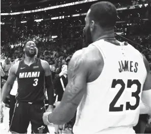  ?? Marcio Jose Sanchez/Associated Press ?? ■ Miami Heat guard Dwyane Wade, left, smiles at Los Angeles Lakers’ LeBron James (23) at the end of an NBA game Monday in Los Angeles.